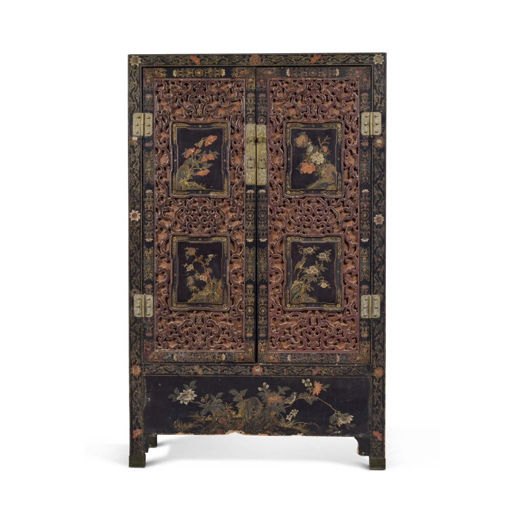 View full screen - View 1 of Lot 722. A gilt and polychromed black lacquer cabinet, Qing dynasty, Qianlong period | 清乾隆 黑漆加彩描金開光花卉圖立櫃.