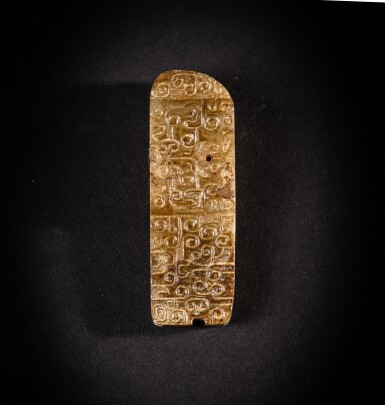 View full screen - View 1 of Lot 85. A brown jade scabbard slide, Eastern Zhou dynasty | 東周 褐玉獸面卷雲紋劍璏.