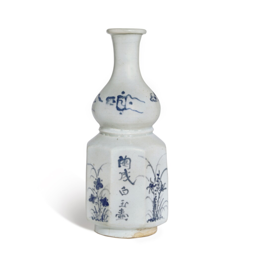 View full screen - View 1 of Lot 928. An inscribed blue and white 'floral and poem' faceted double-gourd vase, Joseon dynasty, 18th century.