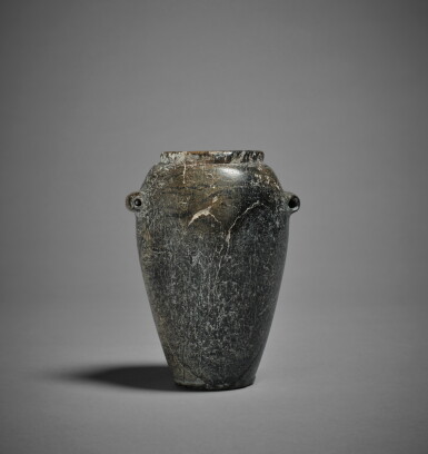 View full screen - View 1 of Lot 304. An Egyptian Variegated Gray and Brown Stone Jar, Late Predynastic period/1st Dynasty, circa 3300-2900 B.C..