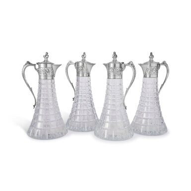 View full screen - View 1 of Lot 392. A Set of Four English Silver-Mounted Cut-Glass Claret Jugs, Collingwood & Co., London, 1977.
