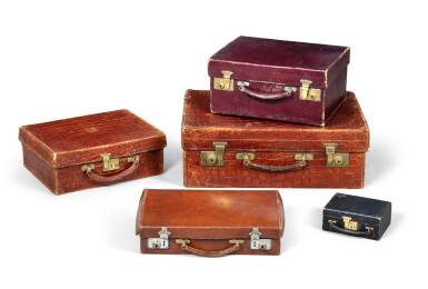 View full screen - View 1 of Lot 2110. Lot comprising five suitcases, three in leather and two in crocodile, mid 20th century | Lot de cinq valises dont trois en cuir et deux en crocodile, milieu du XXeme siècle.