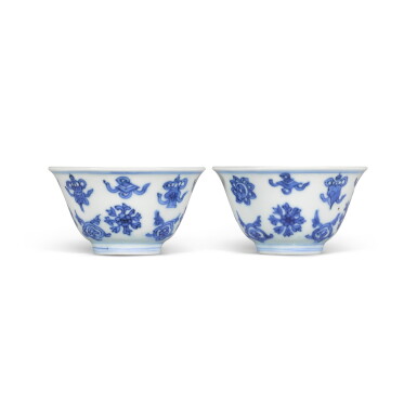 View full screen - View 1 of Lot 214. A pair of small blue and white 'Eight Buddhist Emblems' cups, Qing dynasty, Kangxi period | 清康熙 青花八吉祥紋盃《大明嘉靖年製》仿款一對.