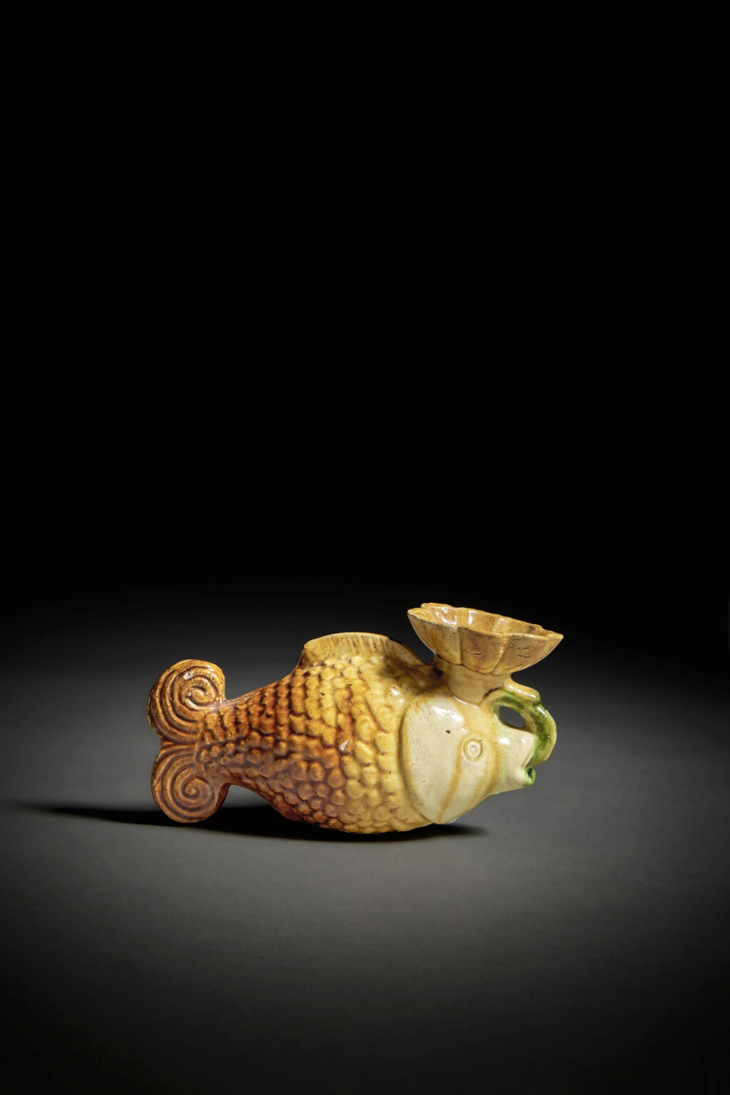 View full screen - View 1 of Lot 186. A sancai-glazed pottery 'fish' oil lamp, Tang / Liao dynasty.