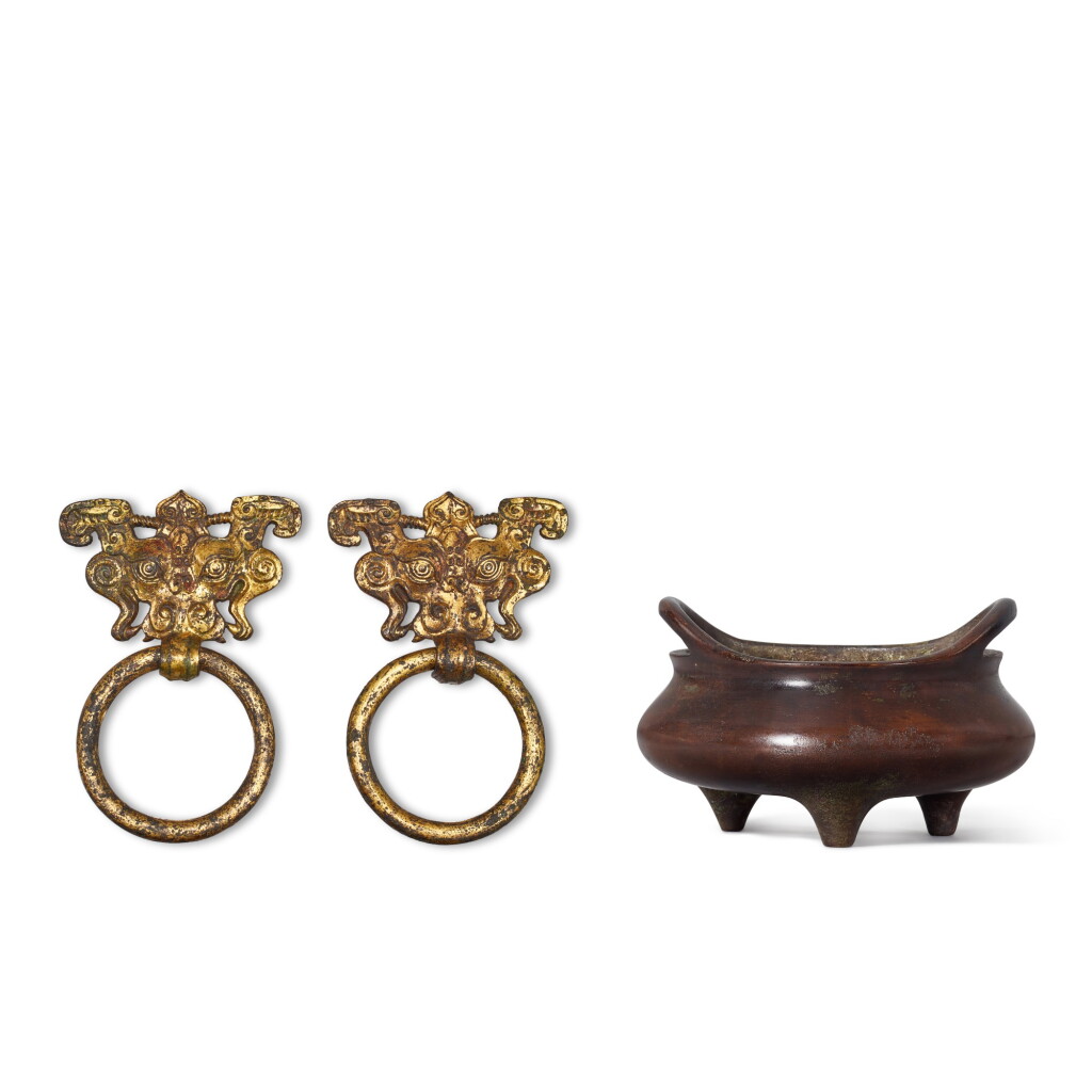 View full screen - View 1 of Lot 569. A bronze tripod incense burner, Qing dynasty, and a pair of gilt-bronze taotie masks, Yuan - Ming dynasty 清 銅橋耳三足爐 《大明宣德五年監督工部官臣吳邦佐造》仿款 及 元至明 鎏金銅饕餮鋪首一對.