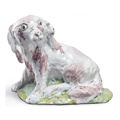 View full screen - View 1 of Lot 679. A BRUSSELS FAIENCE FIGURE OF A SEATED SPANIEL, LATE 18TH CENTURY.