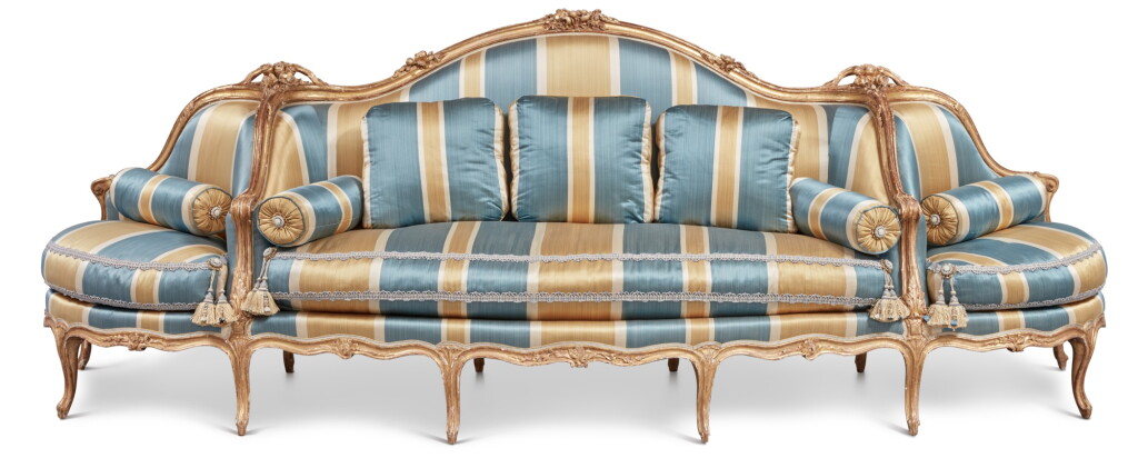 View full screen - View 1 of Lot 64. A Louis XV Carved Giltwood Canapé à Confidents, Mid-18th Century.