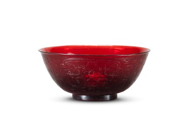 View full screen - View 1 of Lot 205. A carved red Beijing glass bowl Qing dynasty, four-character Qianlong mark and probably of the period | 清或為乾隆 寶石紅透明料如意蓮紋盌 《乾隆年製》款.