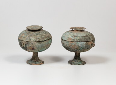 View full screen - View 1 of Lot 34. A rare pair of archaic bronze round vessels and covers, dou Warring States period - Han dynasty | 戰國時代至漢 青銅蓋豆一對.