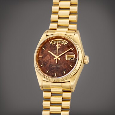 View full screen - View 1 of Lot 103. Reference 18078 Day Date | A yellow gold automatic wristwatch with day, date, bracelet, and burlwood dial, Circa 1979.