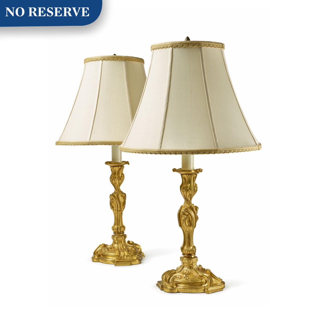 View full screen - View 1 of Lot 285. A PAIR OF LOUIS XV STYLE GILT BRONZE CANDLESTICKS, NOW MOUNTED AS LAMPS.