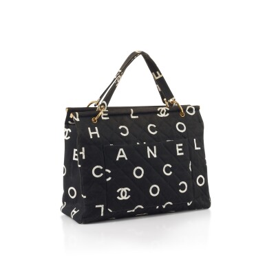 View full screen - View 1 of Lot 4. CHANEL | BLACK CANVAS AND WHITE LOGO PRINT TOTE BAG .