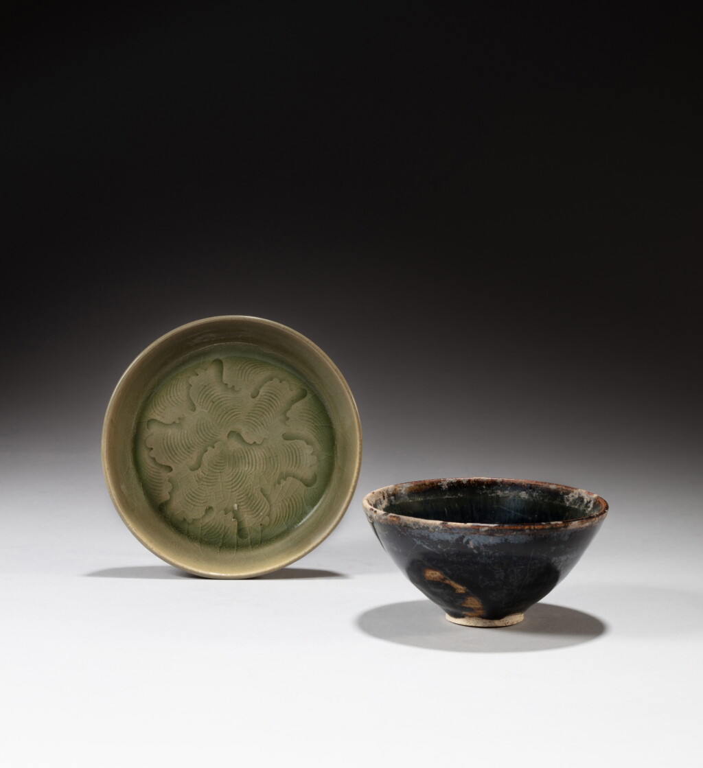 View full screen - View 1 of Lot 116. A Northern black-glazed tea bowl and a small carved 'Yaozhou' saucer, Song dynasty | 宋 黑釉茶盌 及 耀州窰青釉刻劃水波紋小盤 一組兩件.