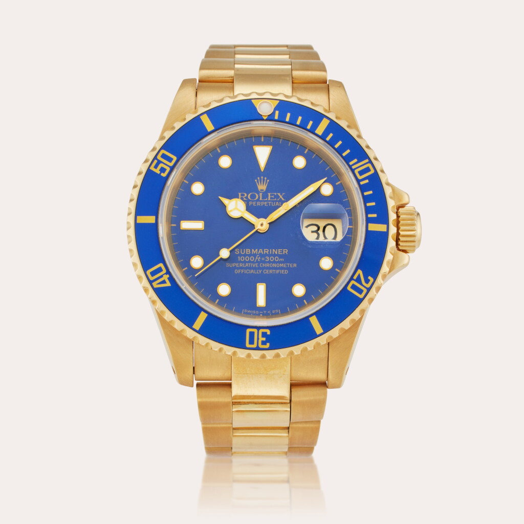 View full screen - View 1 of Lot 615. Reference 16618 Submariner | A yellow gold automatic wristwatch with date and bracelet, Circa 1991.