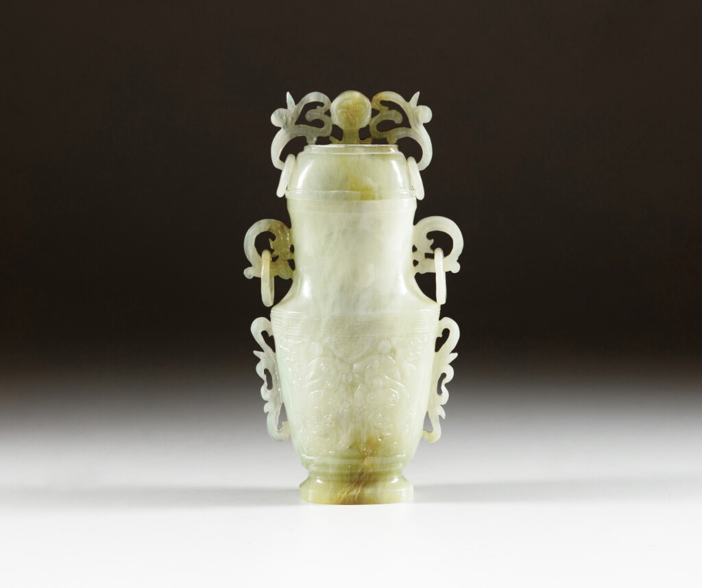 View full screen - View 1 of Lot 184. A celadon jade archaistic vase and cover, Qing dynasty, 19th century | 清十九世紀 青玉雕仿古螭龍環耳蓋壺.
