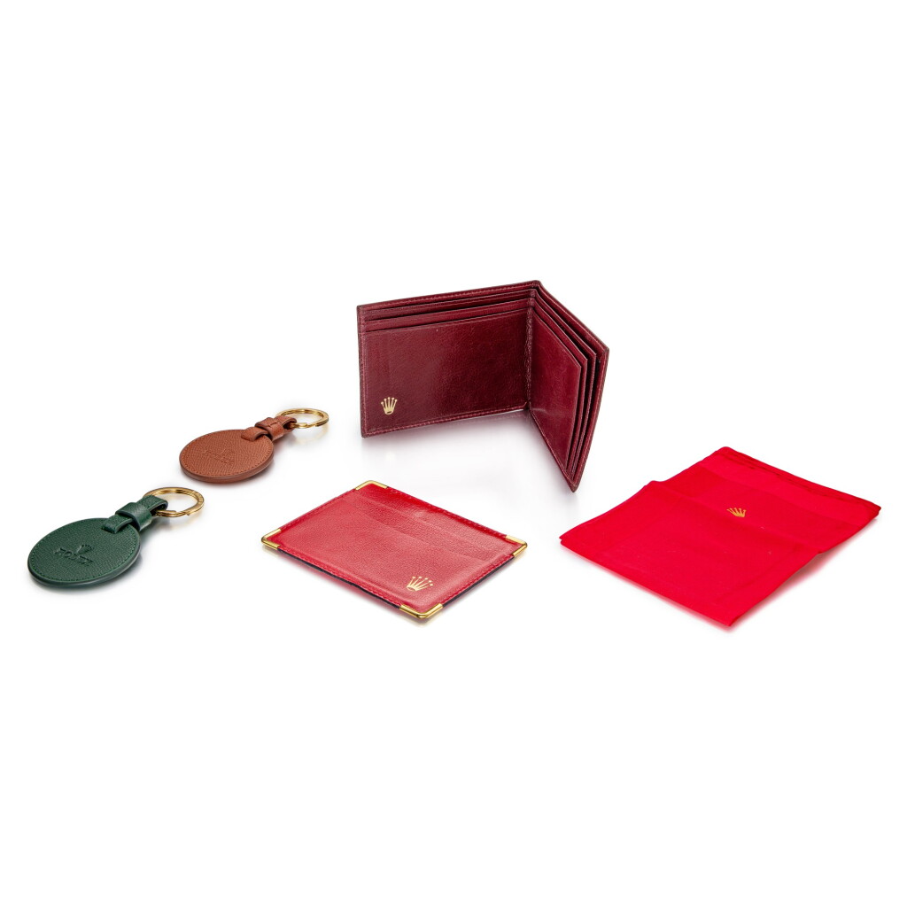 View full screen - View 1 of Lot 8296. A set of leather card holder, wallet and two key chains, Circa 1994 to 2015 | 勞力士 一套皮製卡片夾、錢包及鑰匙扣,約1994到2015年製.