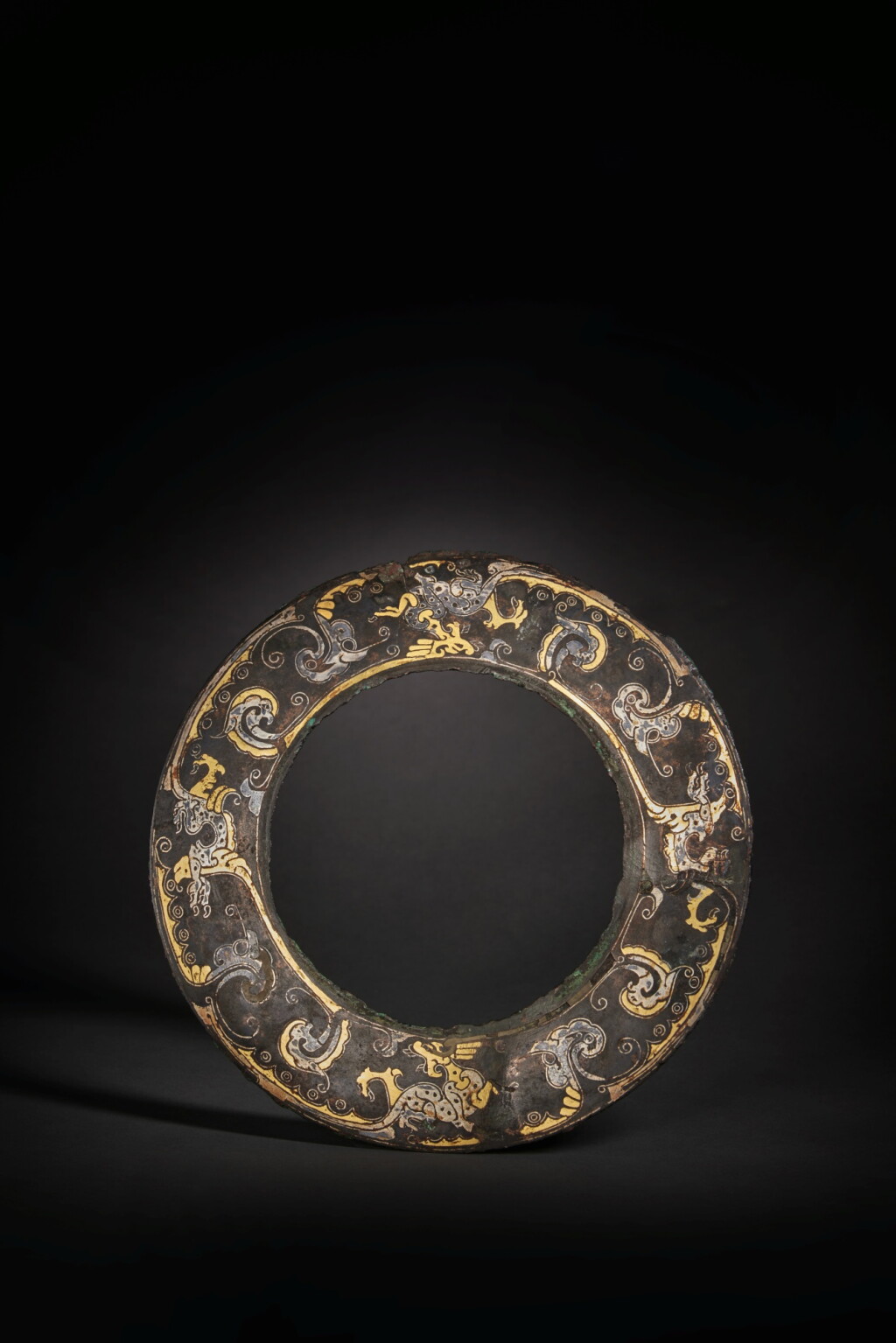 View full screen - View 1 of Lot 142. A rare and important gold and silver-inlaid bronze disc, Late Warring States period / Western Han dynasty.