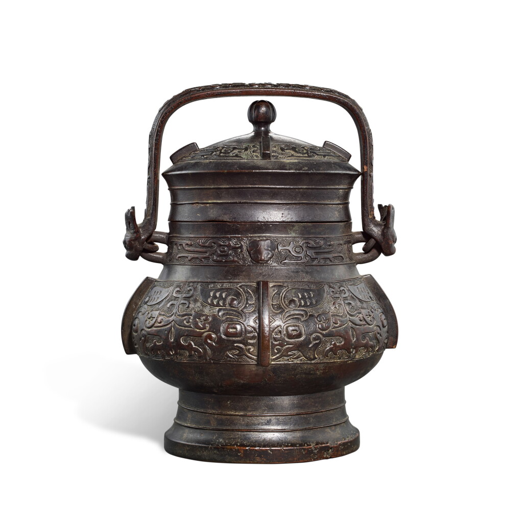 View full screen - View 1 of Lot 5897. A bronze archaistic wine vessel and cover, you, Ming dynasty | 明 銅仿古獸面紋卣.