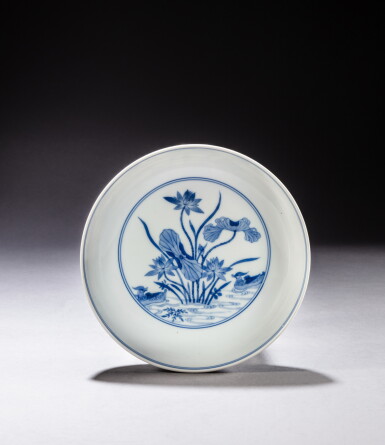 View full screen - View 1 of Lot 157. A blue and white 'mandarin duck and lotus' dish, Mark and period of Yongzheng | 清雍正 青花蓮池鴛鴦臥足盤 《大清雍正年製》款.