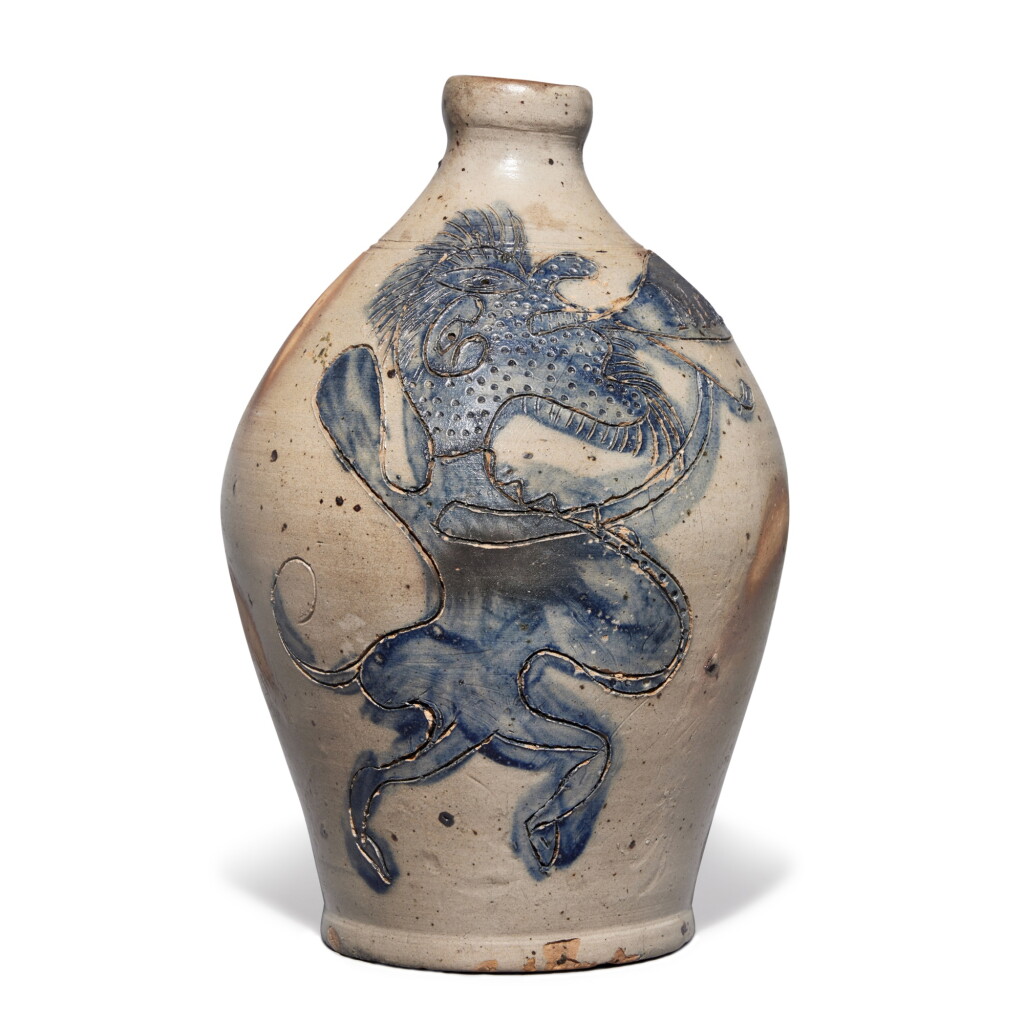 View full screen - View 1 of Lot 35. An Incised and Cobalt-Blue Decorated 'Jersey Devil' Jug, Attributed to Morgan Van Wickle and Green, Old Bridge, New Jersey, circa 1818.