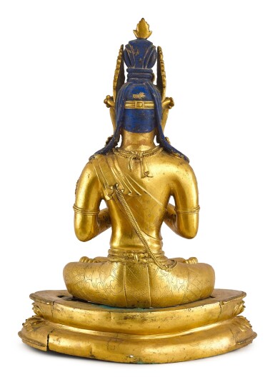 A LARGE GILT-BRONZE FIGURE OF VAIROCANA, TIBET, THE FIGURE CIRCA 1900, THE STAND CIRCA 1400 | 約1900年 藏傳鎏金銅毗盧遮那佛坐像 配 約1400年 鎏金銅蓮座