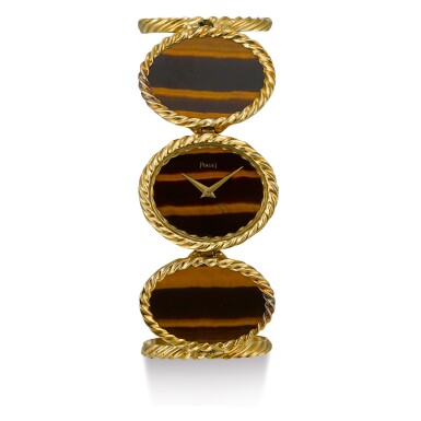 View full screen - View 1 of Lot 113. PIAGET | REFERENCE 9803 D 63, A YELLOW GOLD BRACELET WATCH WITH TIGER'S EYE DIAL, CIRCA 1970.