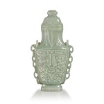 An archaistic celadon jade 'taotie' hanging vase and cover, Qing dynasty, 19th century | 清十九世纪 青玉雕仿古饕餮紋提梁蓋瓶