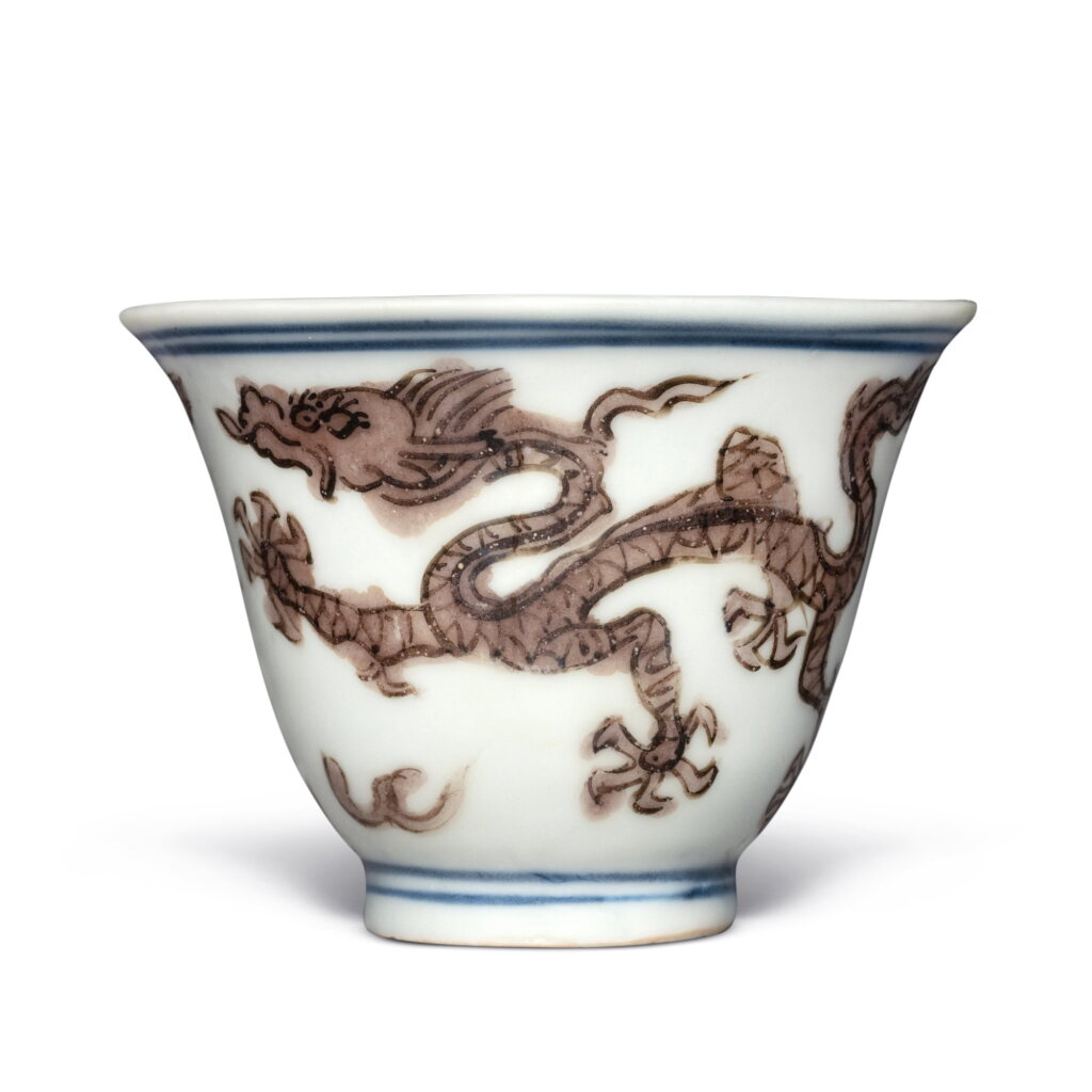 View full screen - View 1 of Lot 241. A small aubergine-enameled blue and white 'dragon' cup, Mark and period of Jiajing | 明嘉靖 紫彩龍紋小盃 《大明嘉靖年製》款.
