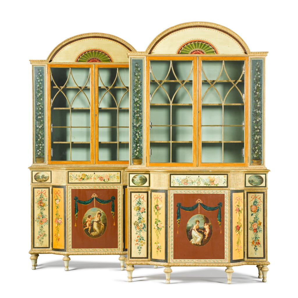 View full screen - View 1 of Lot 21. A pair of George III style polychrome-painted and parcel-gilt satinwood bookcases, after the originals attributed to George Brookshaw.