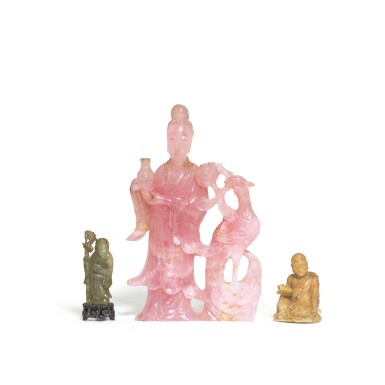 View full screen - View 1 of Lot 99. A carved soapstone figure of a Luohan, Qing dynasty, late 19th century 清十九世紀末 壽山石雕羅漢坐象,青玉壽老立像及 十九 / 二十世紀 粉晶侍女立像 一組三件.