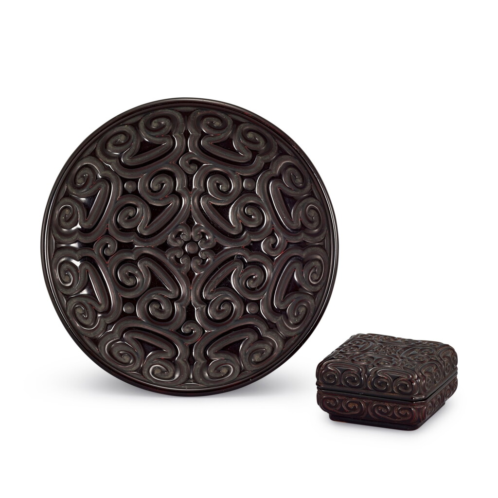 View full screen - View 1 of Lot 741. A CARVED BLACK GURI LACQUER DISH AND A CARVED BLACK GURI LACQUER BOX AND COVER YUAN - MING DYNASTY | 元至明 剔犀鳥面如意紋盤 及 如意紋方蓋盒.