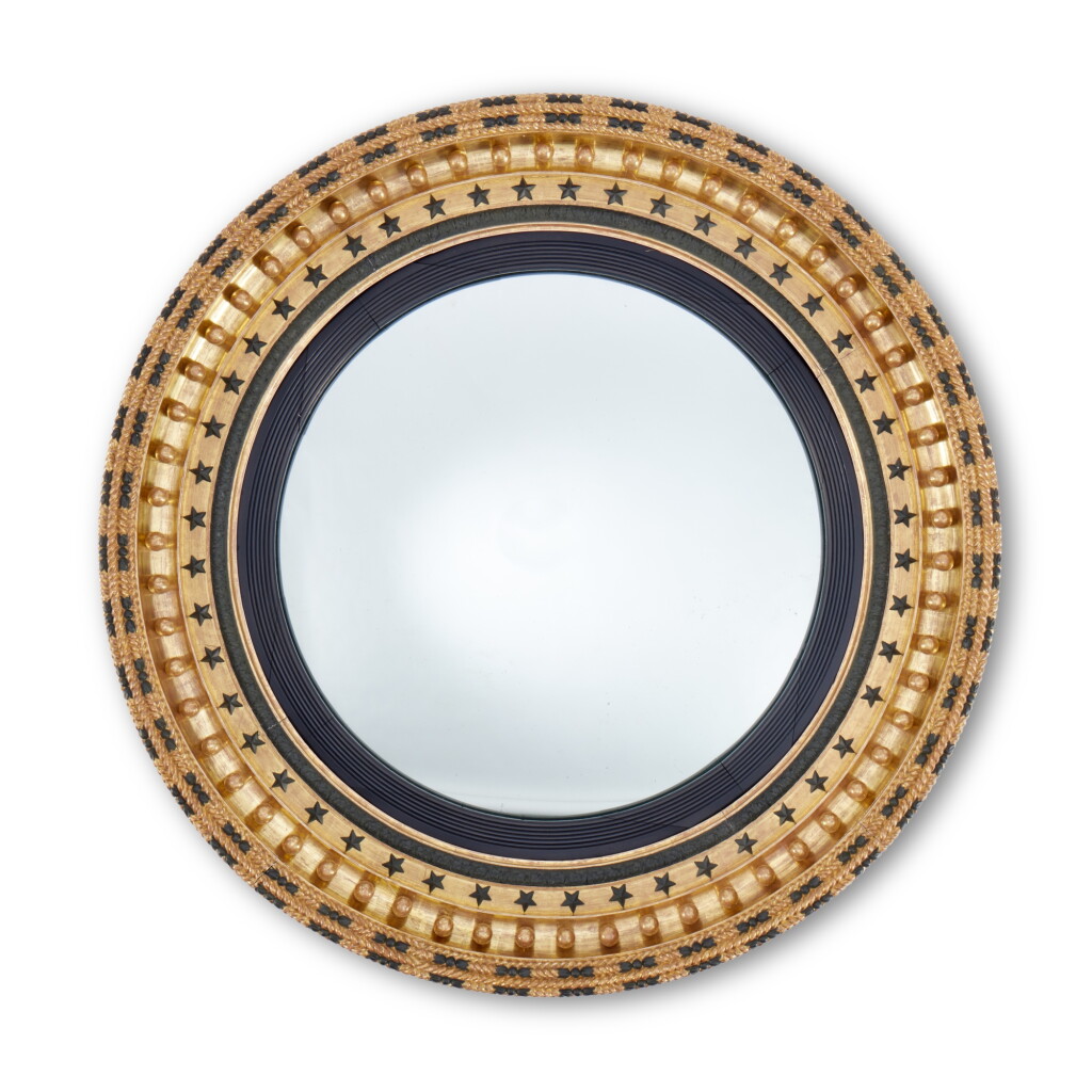 View full screen - View 1 of Lot 40. A Regency Gilt and Ebonized Wood Convex Mirror, first half 19th century.