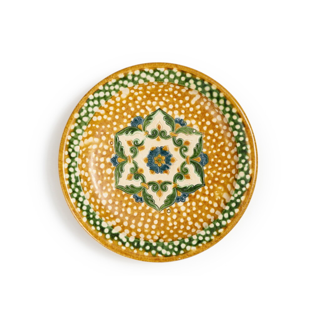 View full screen - View 1 of Lot 173. A sancai and blue-glazed pottery tripod dish, Tang dynasty | 唐 三彩加藍寶相花紋三足盤.