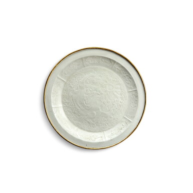 View full screen - View 1 of Lot 158. A rare molded 'Ding' 'Buddhist lion' dish, Northern Song / Jin dynasty | 北宋 / 金 定窰白釉印花佛獅戲繡球紋盤.