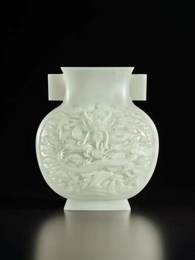 View full screen - View 1 of Lot 283. A superbly carved white jade 'dragon' vase, Qing dynasty, Qianlong period | 清乾隆 白玉雕雲龍戲珠紋雙耳瓶.