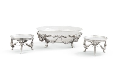 View full screen - View 1 of Lot 65. A French circular centrepiece with glass liner and two circular stands on bases, in the Louis XVI style, Odiot, Paris, circa 1860 | Centre de table et deux présentoirs ronds en argent, doublure en verre, de style Louis XVI, par Odiot, Paris, vers 1860.