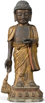 A large parcel-gilt bronze figure of Buddha, Ming Dynasty | 明 局部鎏金銅佛立像