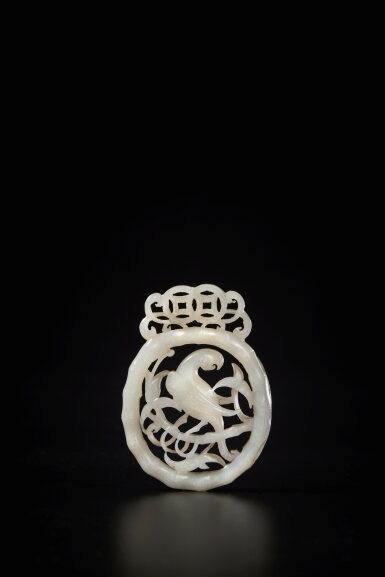 View full screen - View 1 of Lot 103. A white and brown jade 'parrot' pendant, Jin - Ming dynasty.