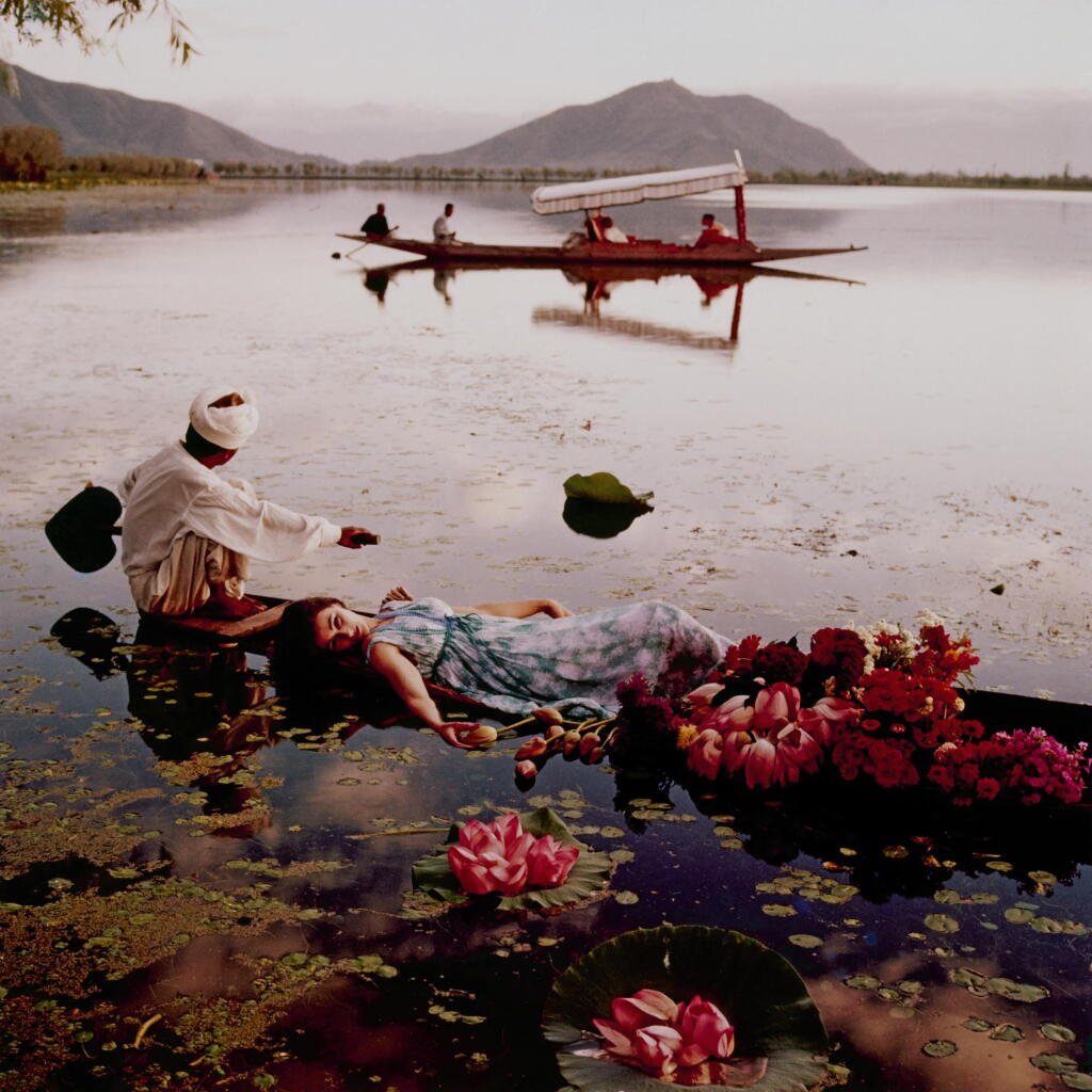 View full screen - View 1 of Lot 17. NORMAN PARKINSON | 'FLOATING WITH FLOWERS', DAL LAKE, KASHMIR II, INDIA, VOGUE, 1956.