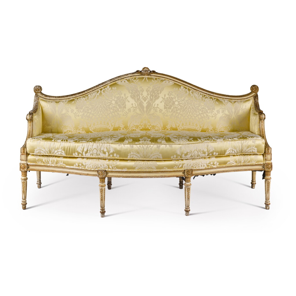View full screen - View 1 of Lot 47. A George III white-painted and parcel-gilt settee, attributed to François Hervé after a design by James Wyatt, circa 1780.