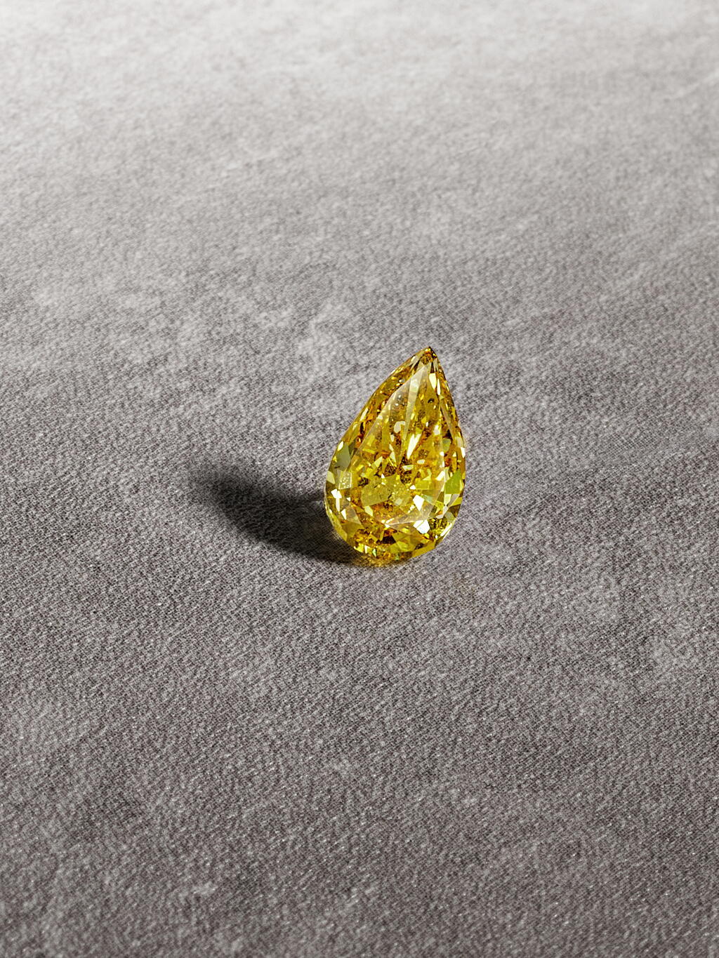 View full screen - View 1 of Lot 24. Unmounted Fancy Deep Orangy Yellow Diamond.