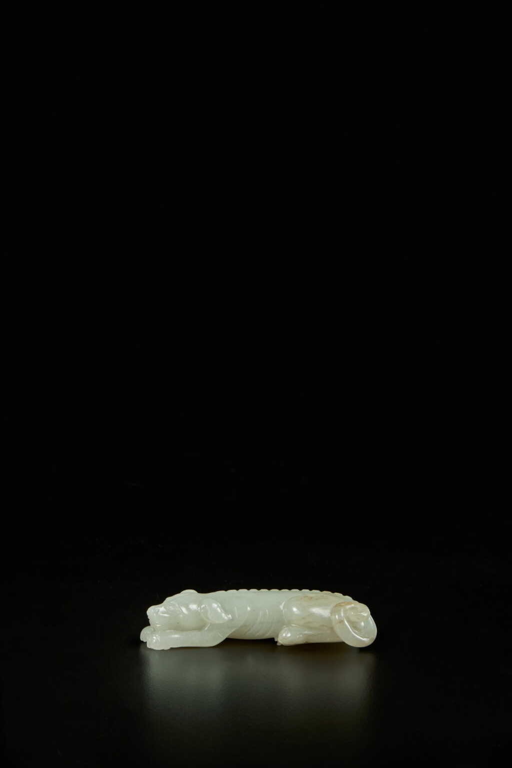View full screen - View 1 of Lot 186. A pale celadon jade carving of a hound, Qing dynasty, 17th / 18th century.
