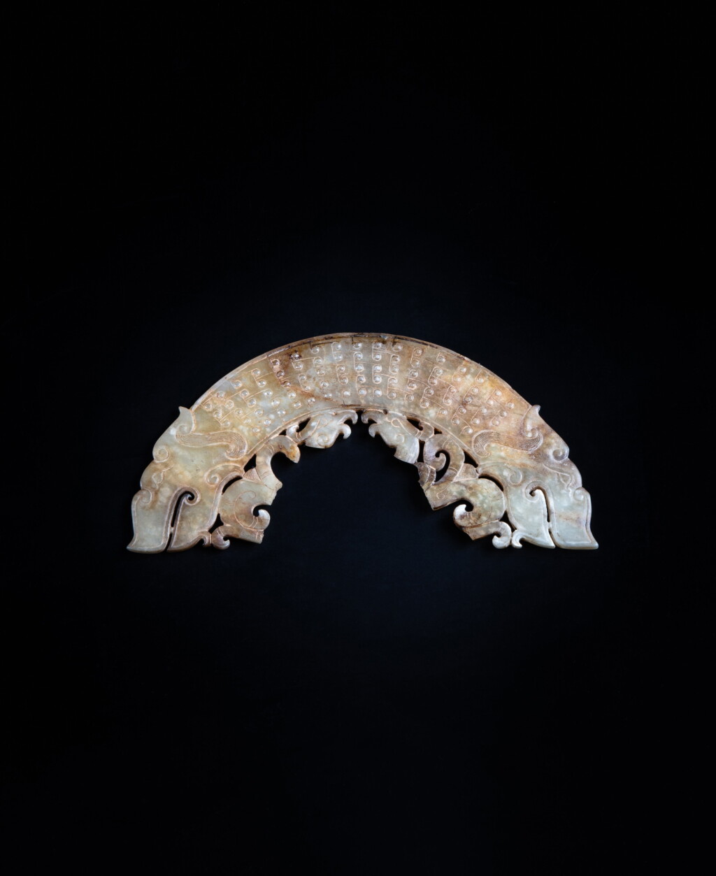 View full screen - View 1 of Lot 35. An archaistic celadon jade 'dragon' pendant, huang Ming dynasty or earlier | 明或更早期 仿古青玉交龍紋璜.