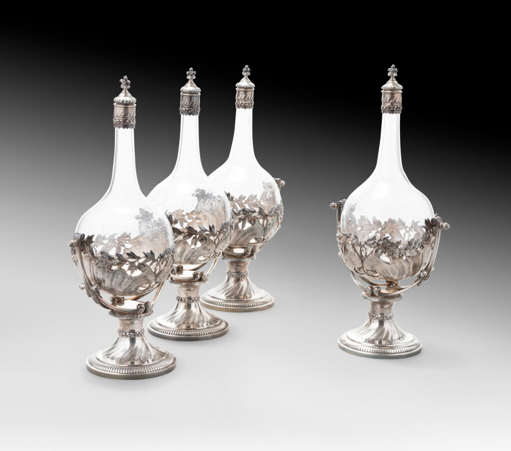 View full screen - View 1 of Lot 55. A set of four engraved glass liqueur bottles mounted in silver made for the opera ballet dancer Rosetta Mauri y Segura, Robert Linzeler, Paris, circa 1885 | Ensemble de quatre flacons à liqueur en verre gravé montés en argent pour la ballerine Rosetta Mauri y Segura par Robert Linzeler, Paris, vers 1885.