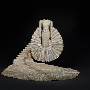 View full screen - View 1 of Lot 1. Haute Couture Full Length Dress with Extended Tail, Designed and Worn by Sherihan on the Television Show “Alf Layla Wa Layla ('Thousand and One Nights')” in 1987. Executed in the Atelier by Adnan Akbar..