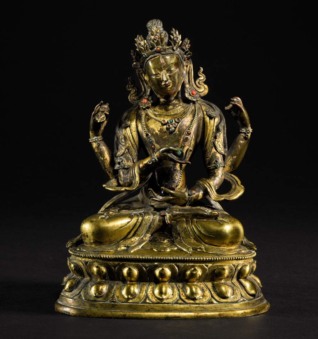 View full screen - View 1 of Lot 190. A GILT-BRONZE FIGURE OF A BODHISATTVA QING DYNASTY, 18TH CENTURY | 清十八世紀 鎏金銅四臂菩薩坐像.