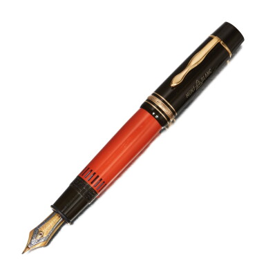 View full screen - View 1 of Lot 28. MONTBLANC | A BLACK AND ORANGE RESIN FOUNTAIN PEN, CIRCA 1992.