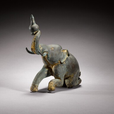 View full screen - View 1 of Lot 89. A gilt-bronze figure of a seated elephant, Thailand, 19th Century.