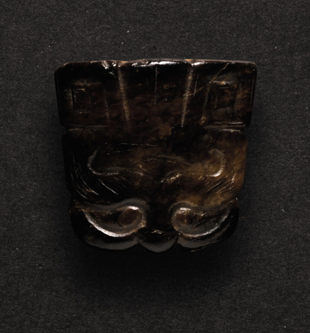 View full screen - View 1 of Lot 229. A SMALL BLACK JADE CARVING OF A TAOTIE MASK PENDANT SHANG DYNASTY OR LATER | 商或以後 玉饕餮紋珮.
