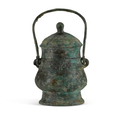 View full screen - View 1 of Lot 100. An archaic bronze ritual wine vessel and cover, You, Western Zhou dynasty | 西周 買王卣.